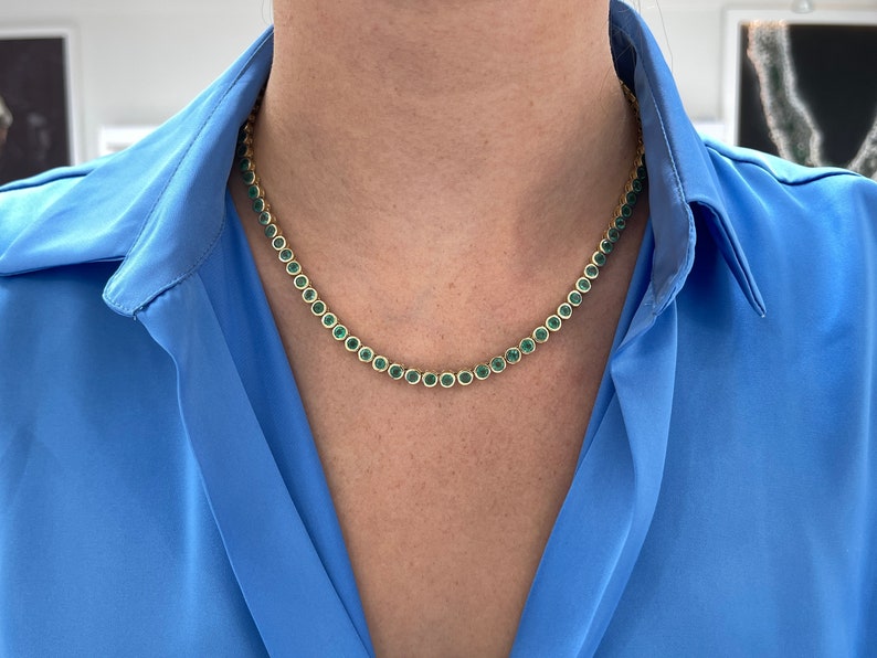 14K gold tennis necklace with round medium green emeralds totaling 25.50 carats, bezel-set by Colombian Emerald.