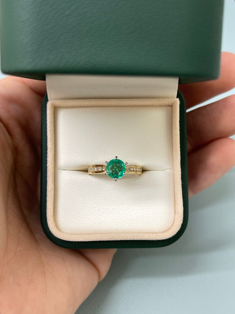 Two-toned 14K emerald and diamond accent engagement ring with 6 prongs and round cut by Colombian Emerald.