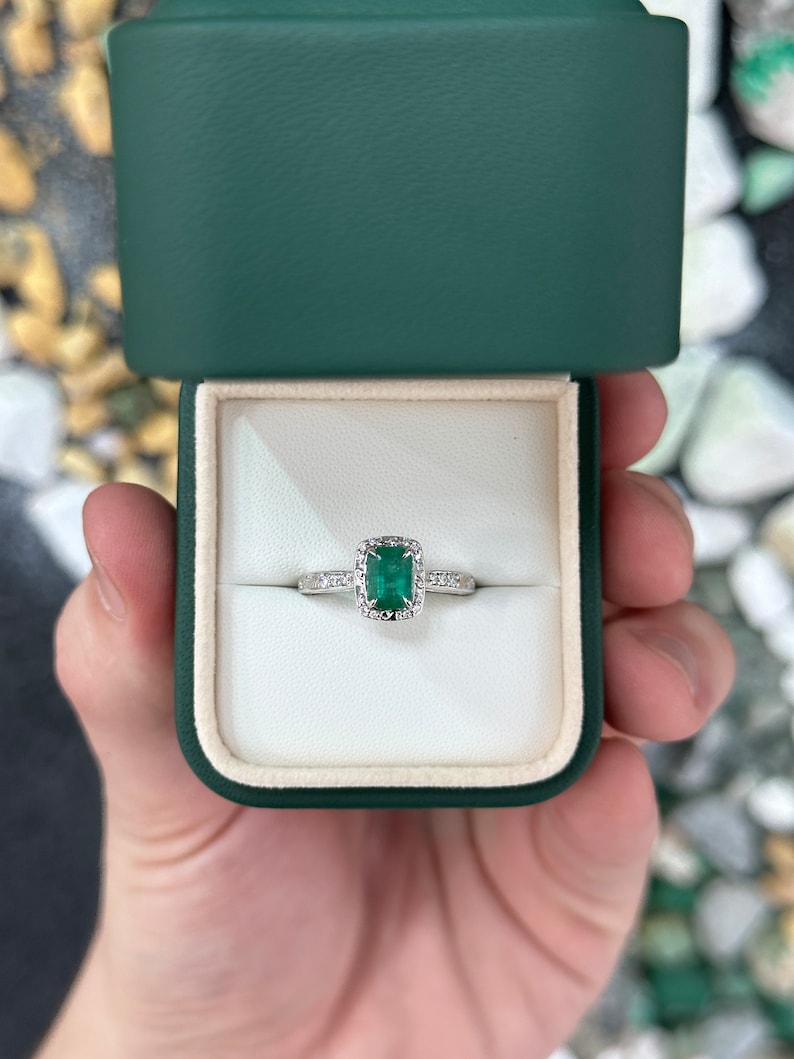 Vintage-inspired 14K engagement ring with floral design, emerald cut center stone, diamond accents, by Colombian Emerald.
