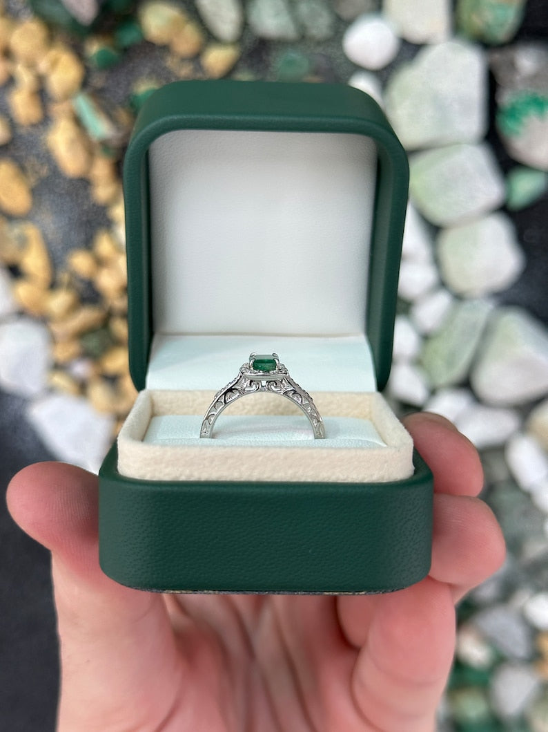 Vintage-inspired emerald cut engagement ring with floral design, diamond accents, 14K gold from Colombian Emerald brand.
