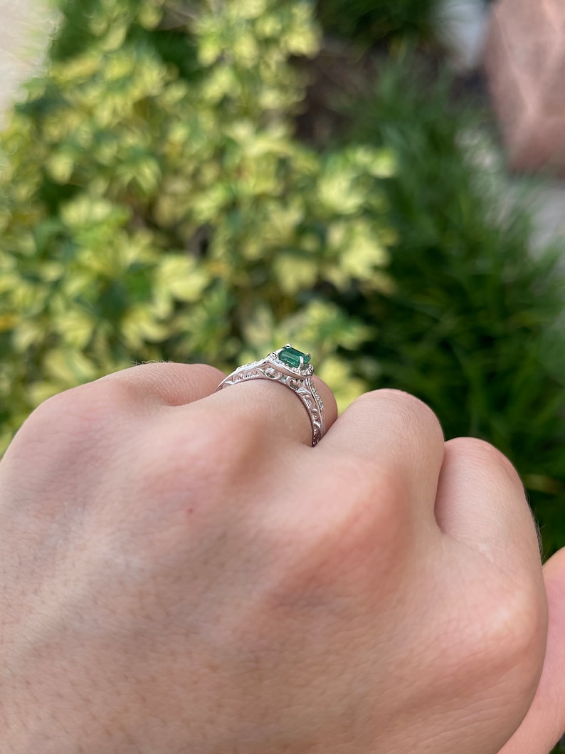 Vintage-inspired 14K engagement ring with floral design, emerald cut emerald, and diamond accents by Colombian Emerald.