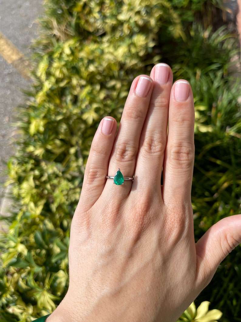 Colombian Emerald 1.28ct AAA quality pear cut engagement ring with 3 prongs in 18K white gold, showcasing the elegant gemstone.