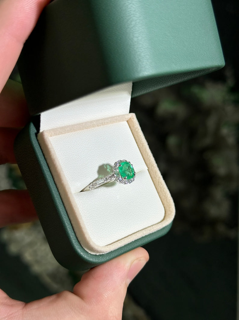 Colombian Emerald engagement ring featuring a 1.55tcw cushion cut vivid green emerald with diamond halo and baguette accents.