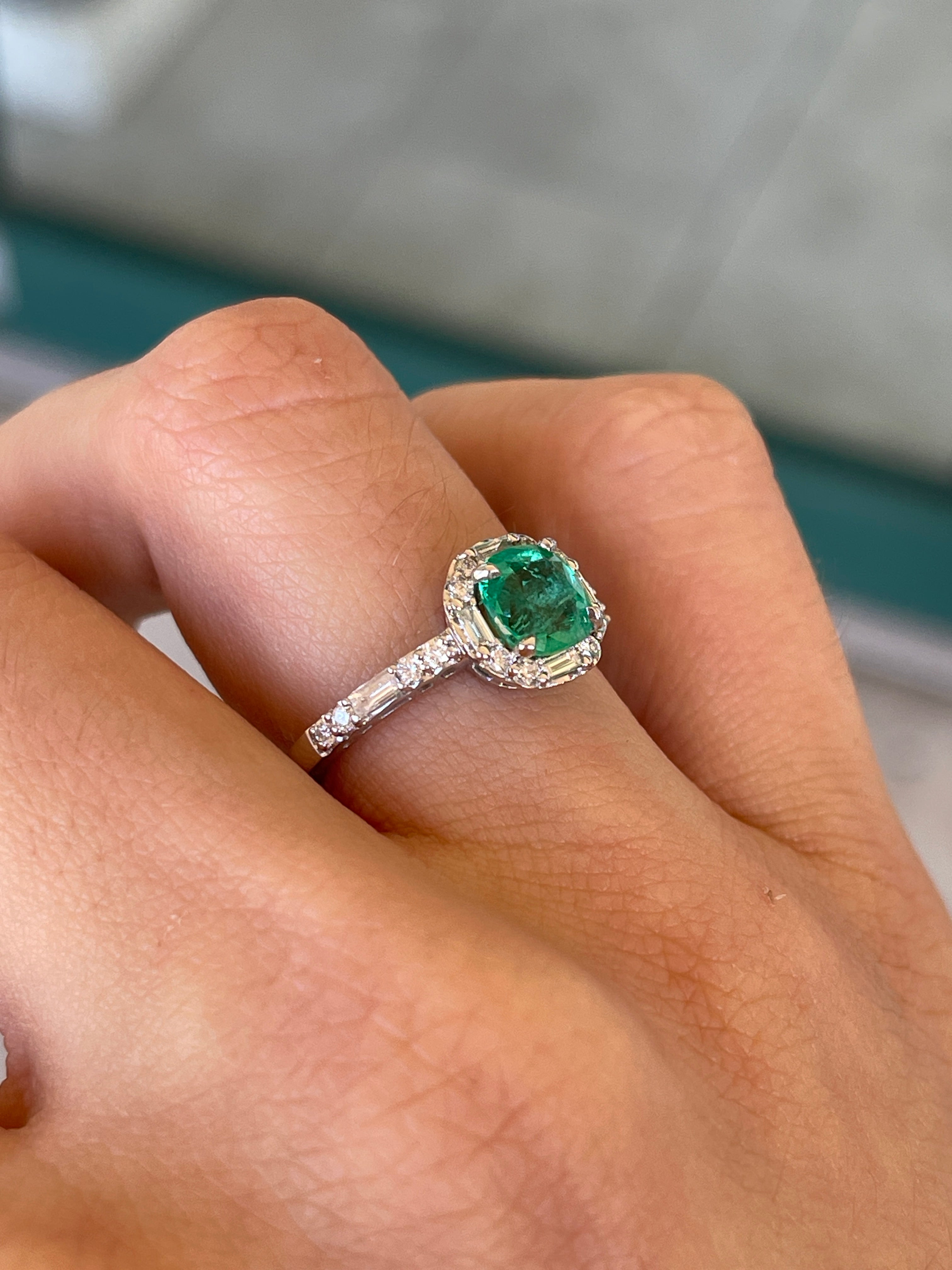 Colombian Emerald 14K gold engagement ring with a 1.55 tcw cushion cut vivid green emerald and diamond halo, showcasing intricate design.