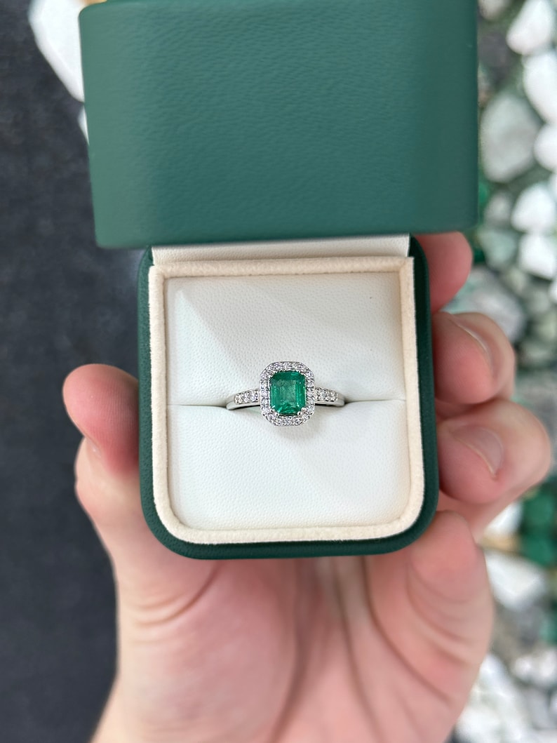 High-quality Zambian emerald cut emerald and diamond halo engagement ring in 14K gold by Colombian Emerald.