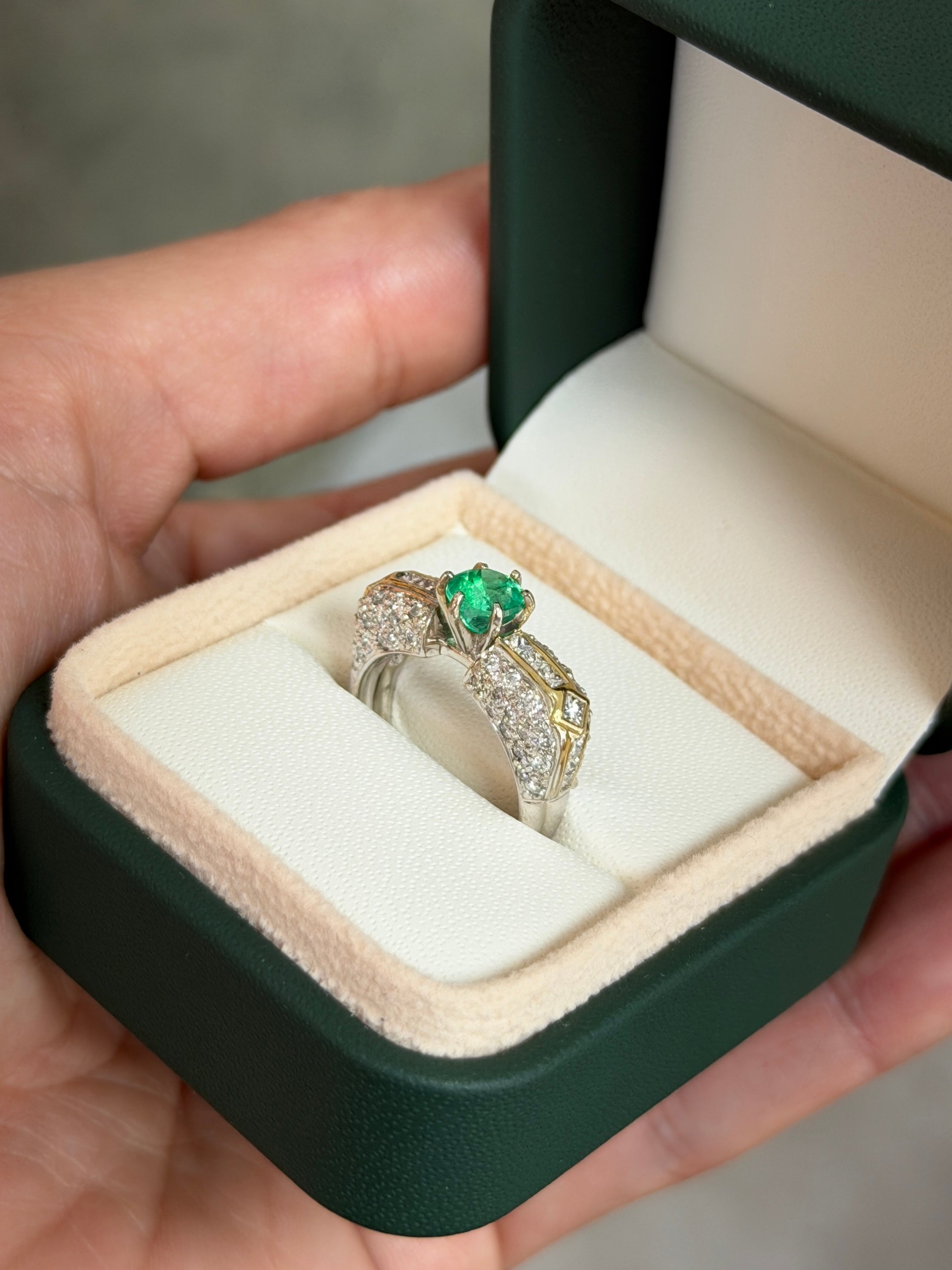 18K gold Colombian Emerald engagement ring with 1.85 carats round-cut emerald and diamond accents, elegant and sparkling jewelry piece.