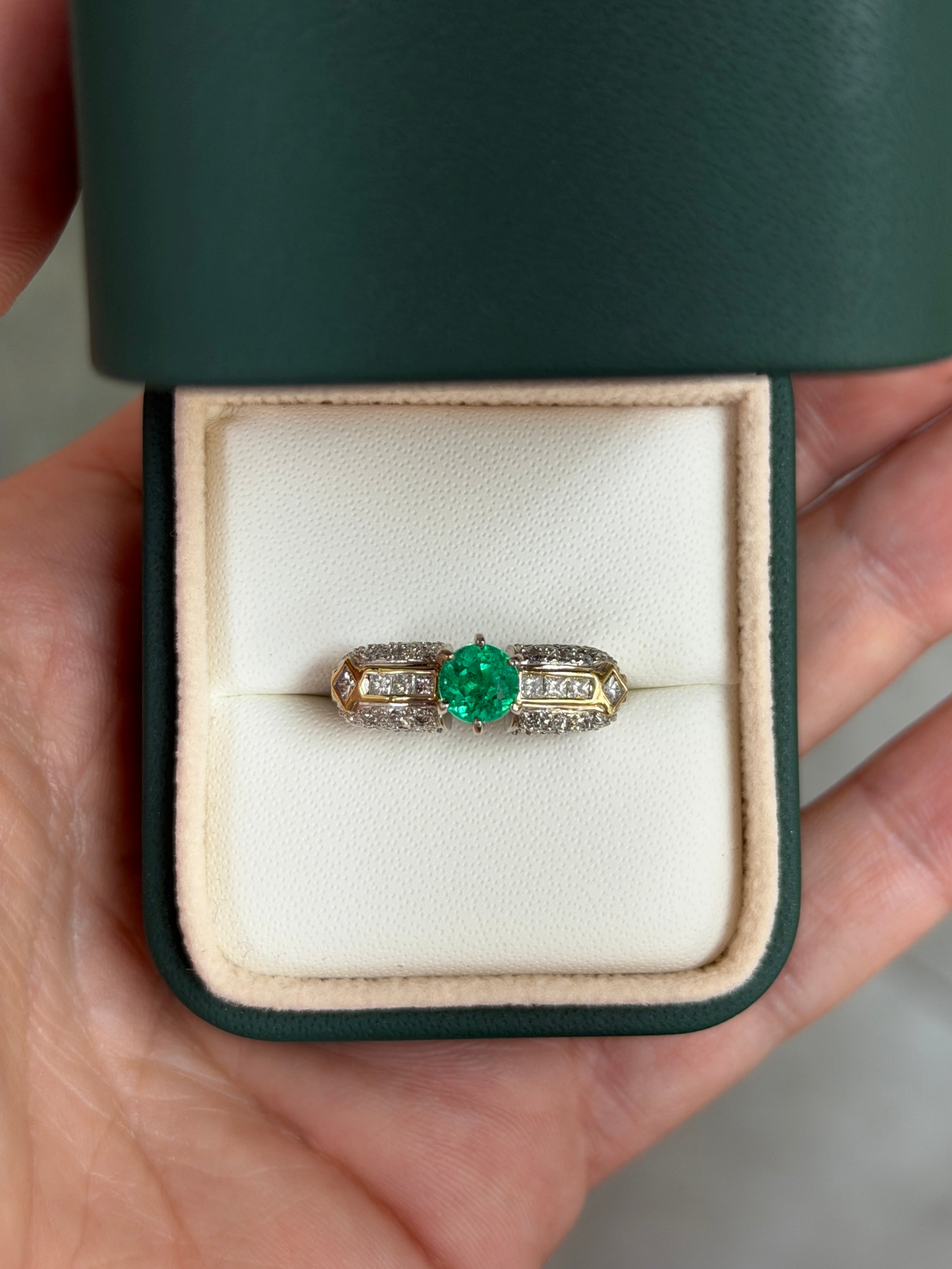 18K gold engagement ring with 1.85 tcw round cut Colombian emerald and diamond accents, showcasing elegant gemstone details.