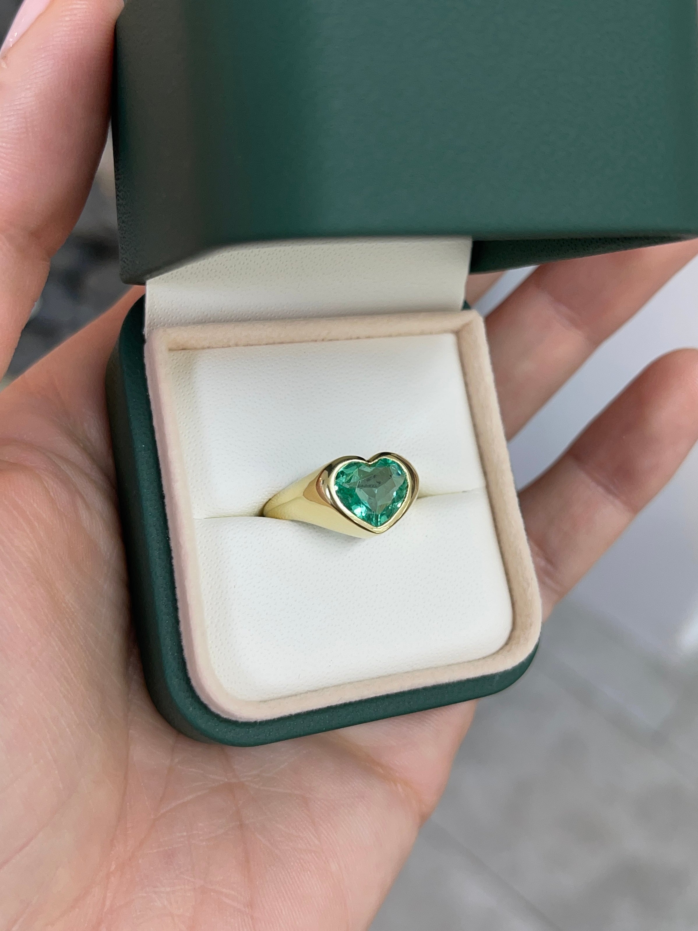18K gold heart-cut Colombian emerald bezel solitaire engagement ring for Nabil and Tara, unisex design, gemstone focus.