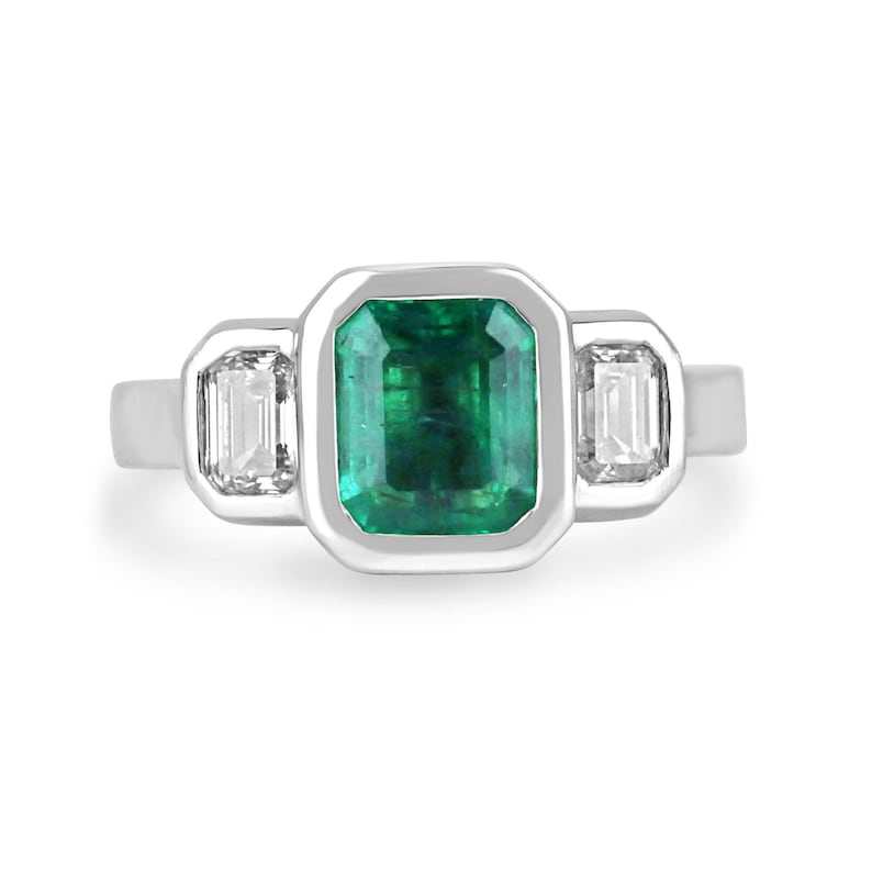 14K gold engagement ring with three natural emerald cut diamonds totaling 2.25 carats, featuring a Colombian Emerald brand design.