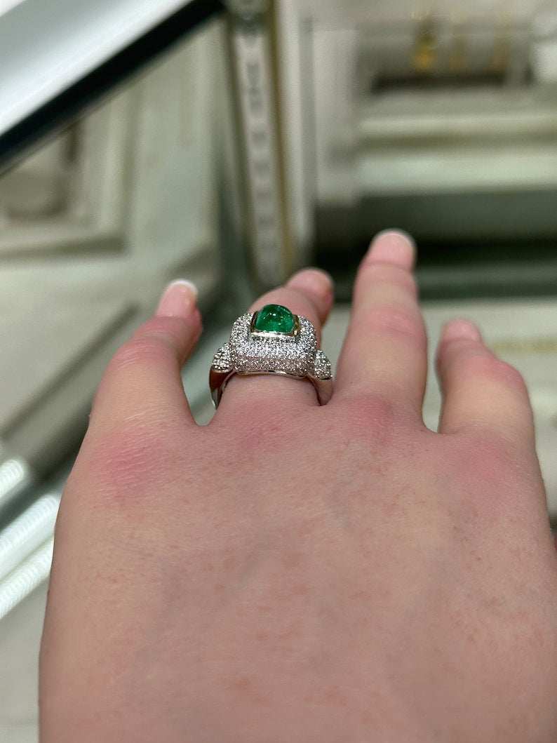 Colombian Emerald engagement ring featuring a 2.54-carat cluster sugarloaf emerald surrounded by diamond accents in 14K gold.
