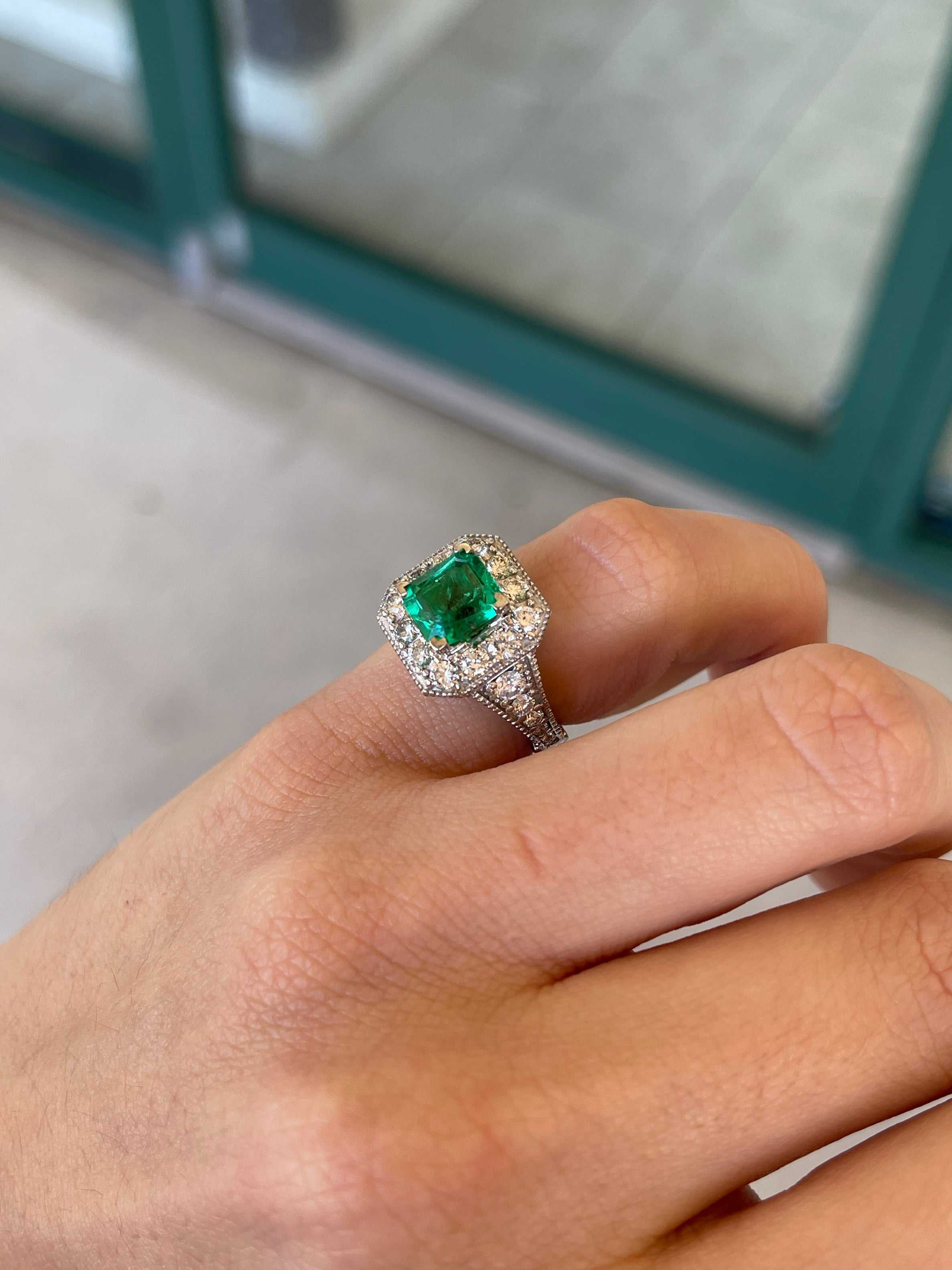 Colombian Emerald engagement ring with a 3.08tcw AAA vivid green emerald cut diamond halo in 14K gold.