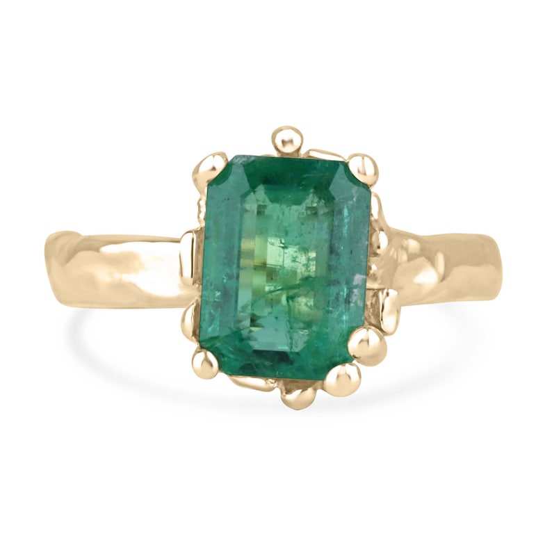 14K gold engagement ring featuring a 3.10ct lush green emerald solitaire with organic gold nugget design. Colombian Emerald brand.