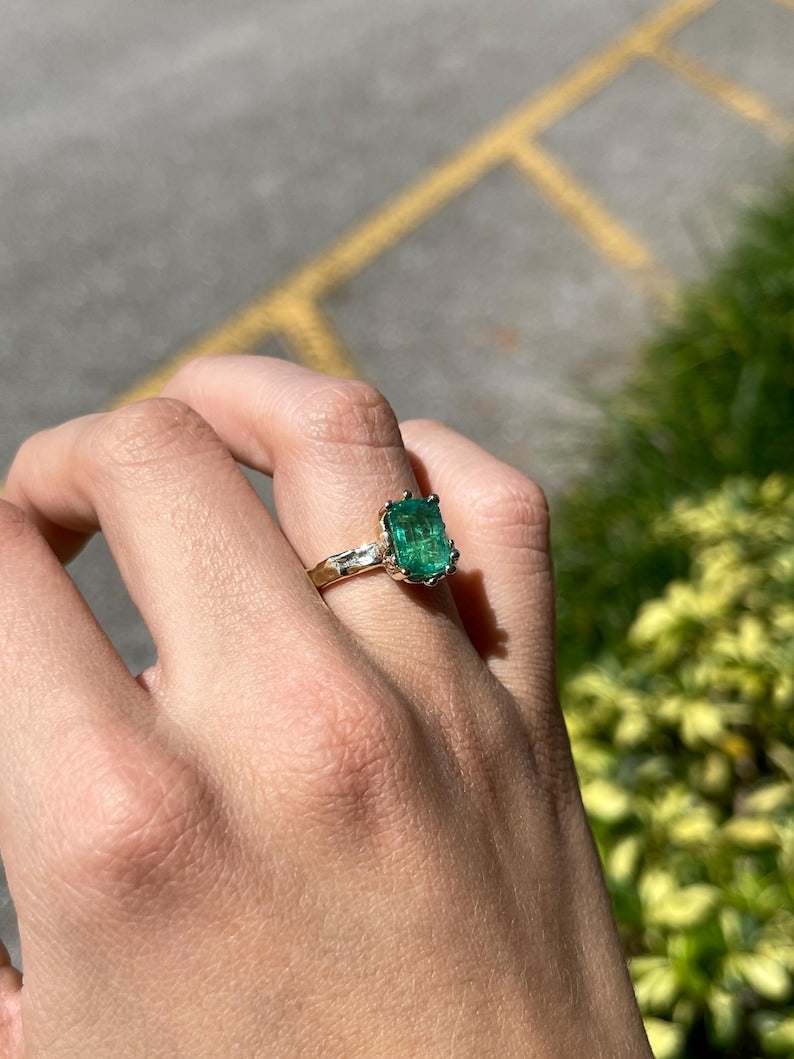 14K gold engagement ring with a 3.10ct lush green emerald solitaire set in Colombian Emerald brand jewelry.