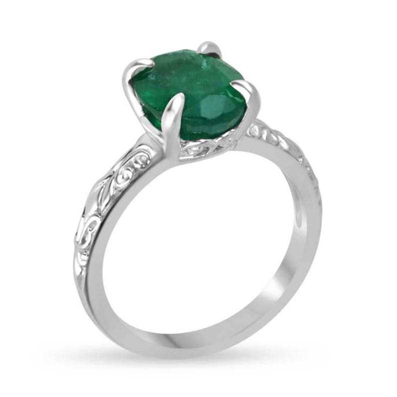 14K white gold engagement ring featuring a 3.11-carat dark green oval emerald solitaire by Colombian Emerald.