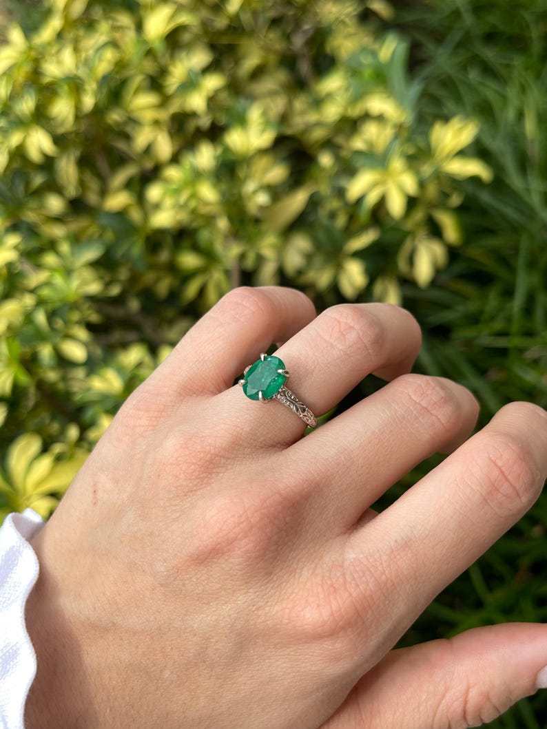 14K white gold engagement ring with a 3.11 carat dark green oval emerald solitaire from Colombian Emerald.