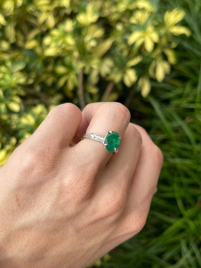14K white gold engagement ring featuring a 3.11ct dark green oval emerald solitaire, Colombian Emerald brand.