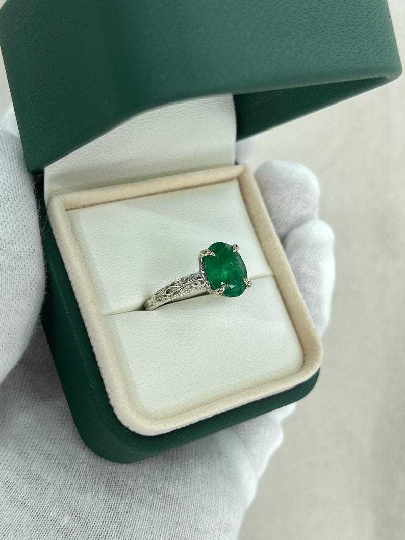 14K white gold engagement ring featuring a 3.11ct dark green oval emerald solitaire by Colombian Emerald.