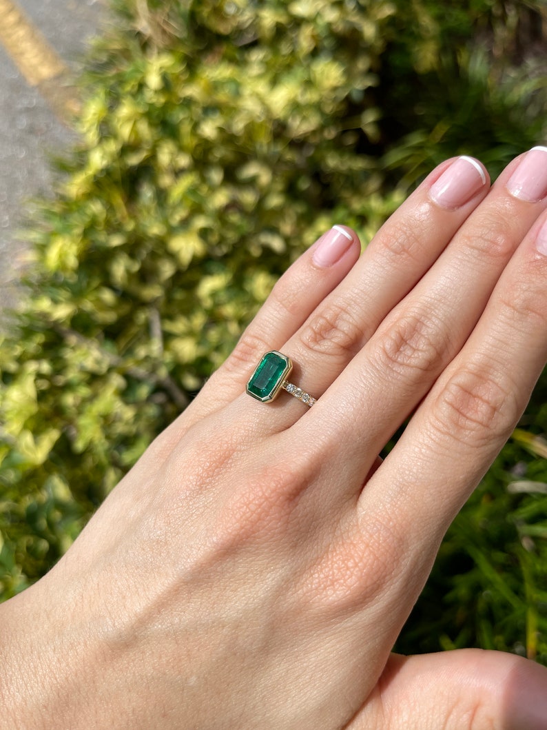 Green emerald cut engagement ring with diamond accents in 14K gold, featuring a 3.59 carat emerald from Colombian Emerald.