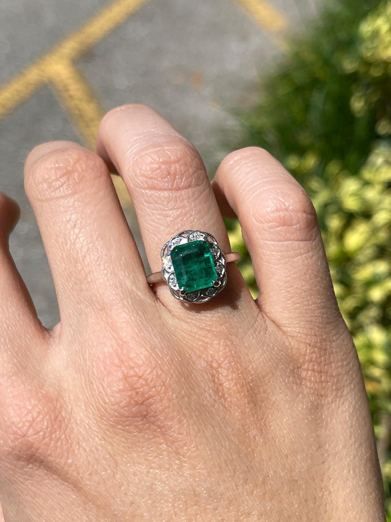 14K white gold engagement ring featuring a 3.60 carat green emerald and diamond floral design by Colombian Emerald.