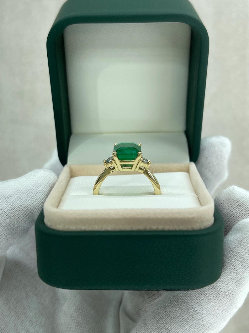 14K green emerald cut and round diamond three stone engagement ring with 4.27tcw from Colombian Emerald.