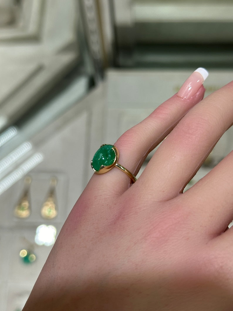 14K dark green emerald solitaire engagement ring with a 4.29ct oval cabochon from Colombian Emerald, showcasing a sleek dome design.