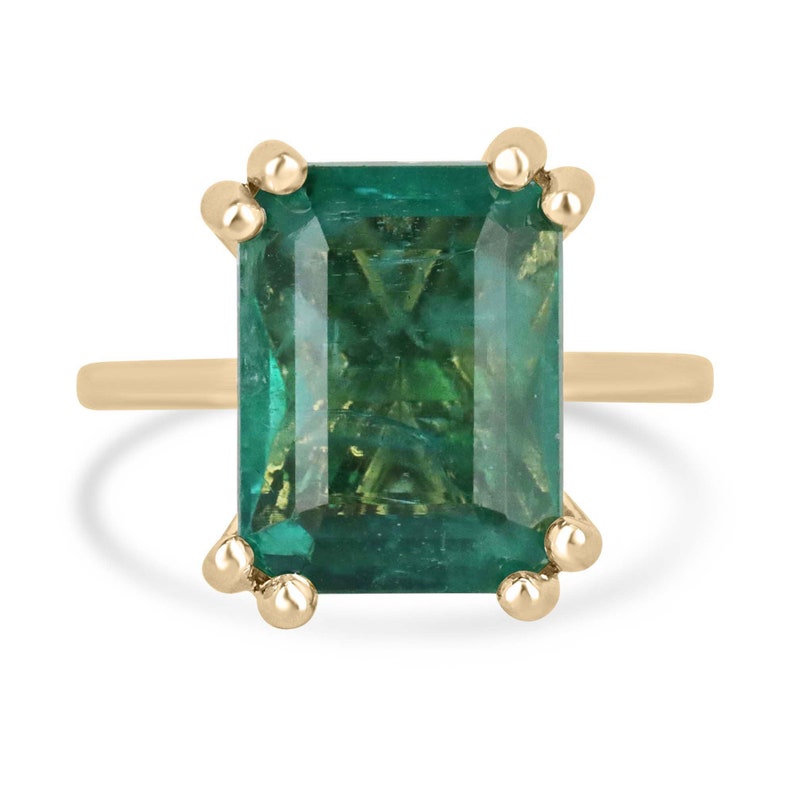 14K Colombian Emerald engagement ring with a 7.35ct emerald cut solitaire stone in chunky claw prongs, showcasing elegant craftsmanship.