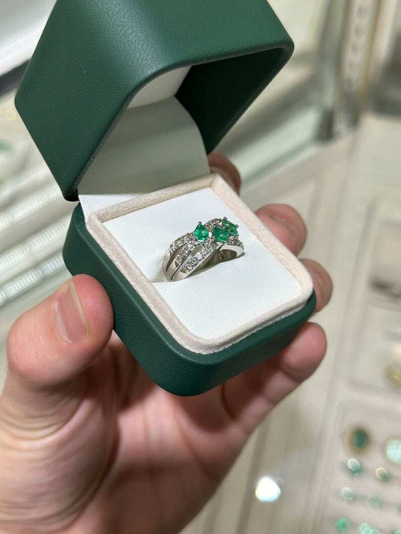 Ladies emerald ring featuring 1.20tcw natural emeralds and diamond accents in a 14K gold princess cut 3-stone pave design.