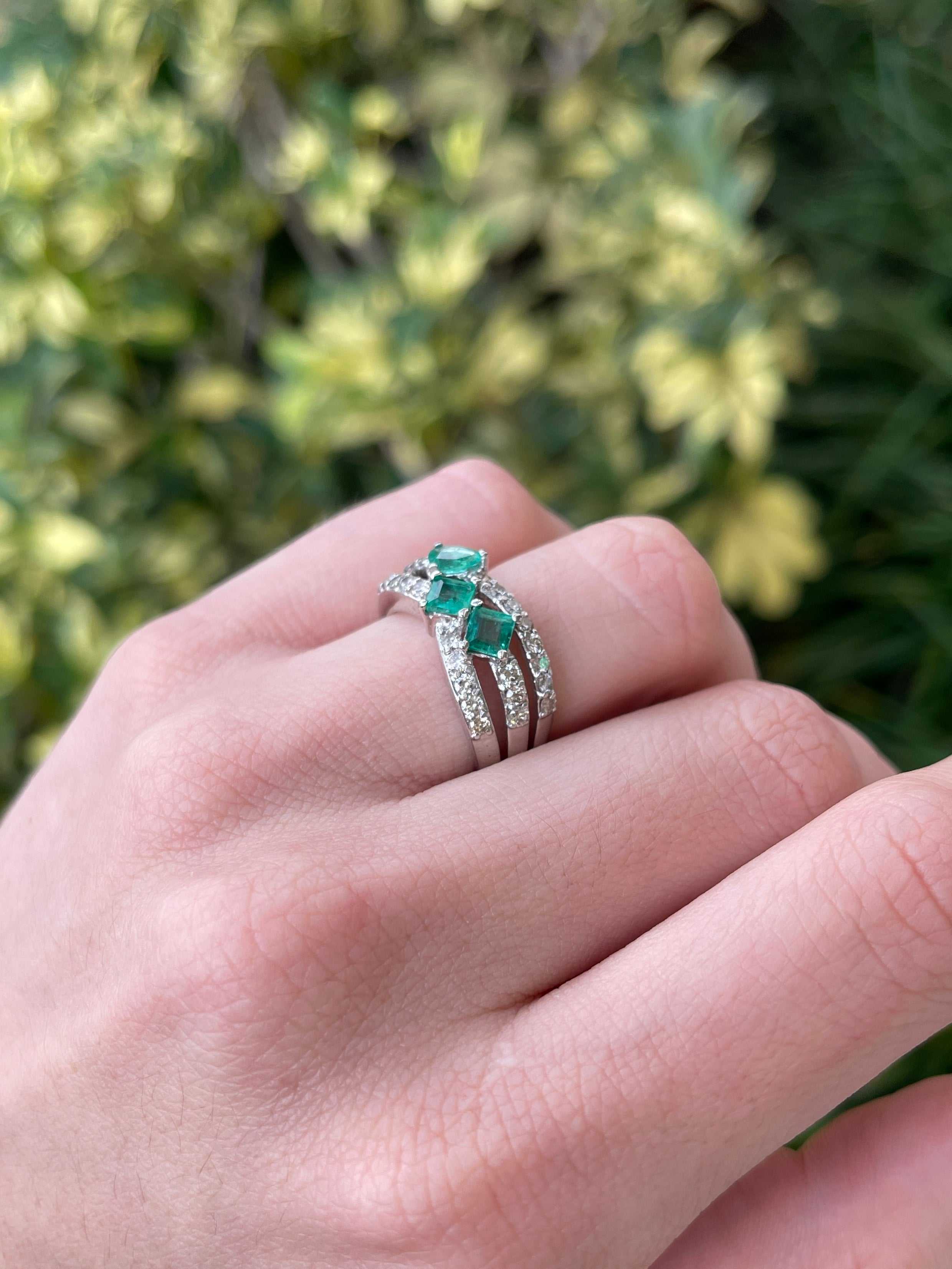 Colombian Emerald 14K gold ladies ring with 1.20tcw natural emeralds and diamond accents in a three-stone princess cut design.
