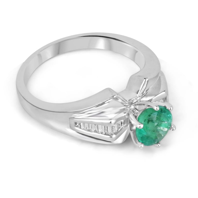 Colombian Emerald Ladies Ring with 1.25tcw diamonds, 18K white gold, round emerald center, and tapered baguette diamond accents.