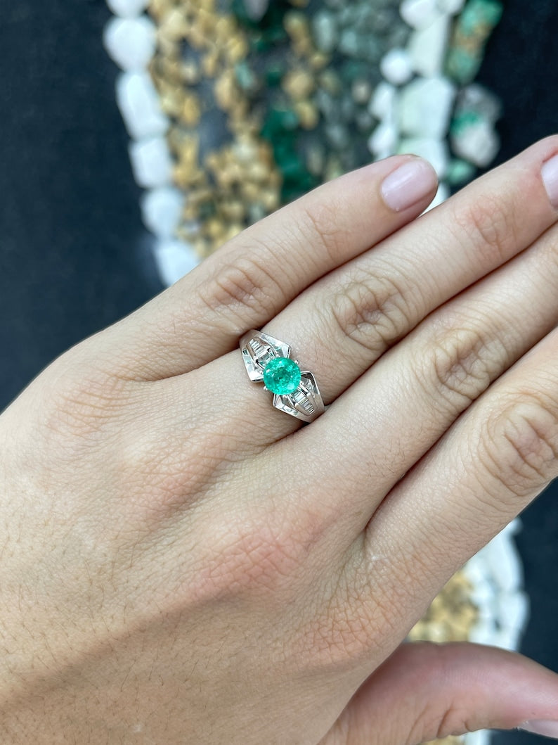 Colombian Emerald Ladies ring with 1.25 carat total weight, 18K white gold, round emerald, tapered baguette diamond accents, 6 prongs