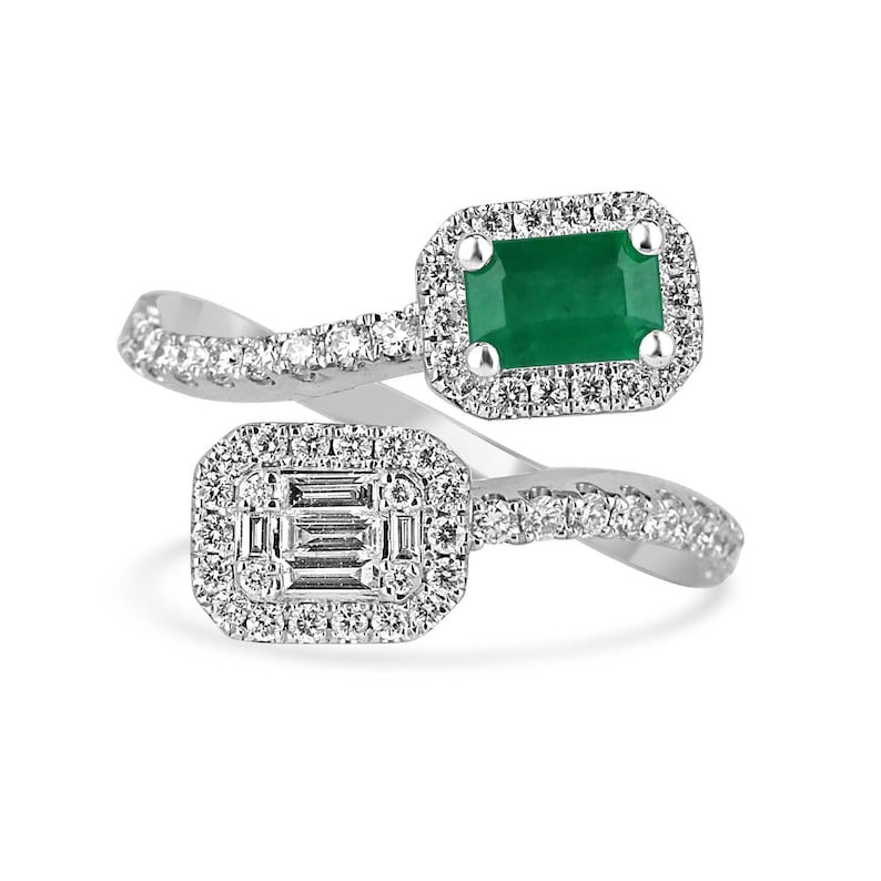 Ladies emerald ring featuring 1.51tcw Colombian emeralds with round cut, baguette, and brilliant stones on a 14K gold bypass shank.