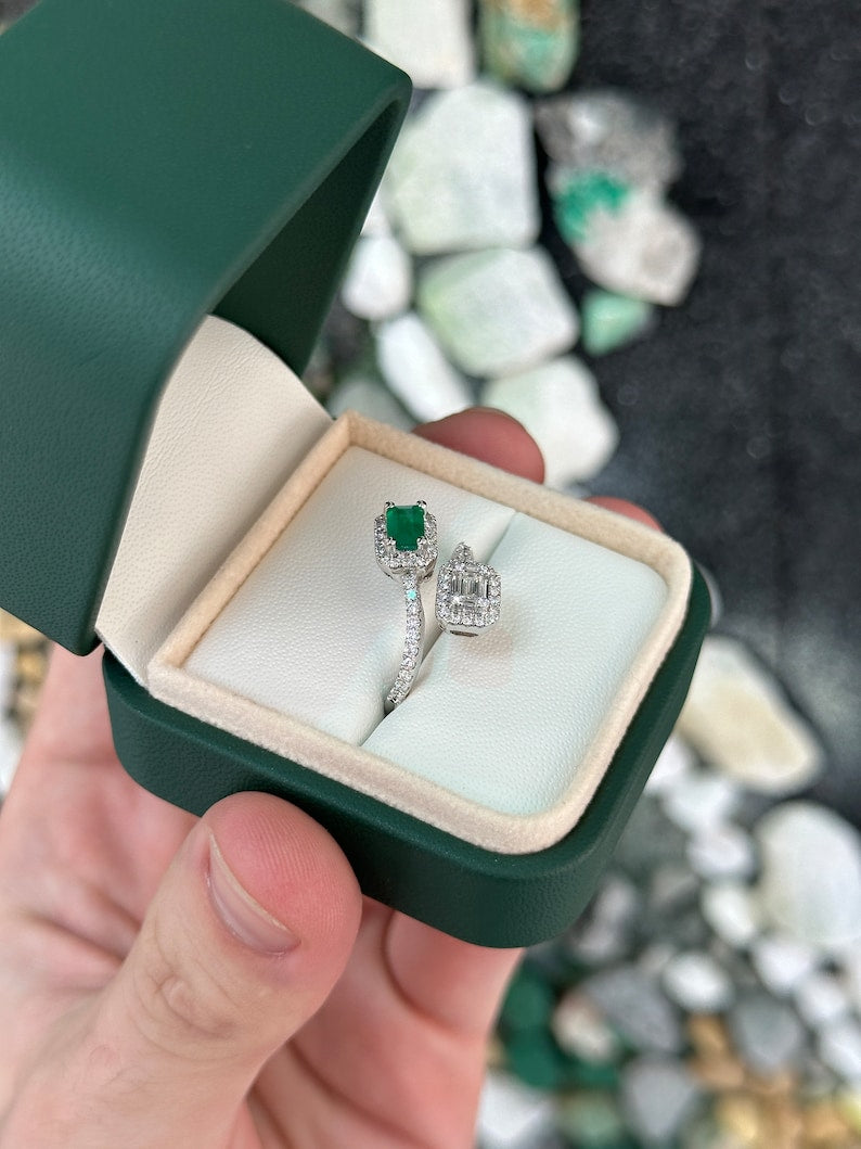Colombian emerald ladies ring with 1.51tcw baguette and round cut green emeralds on a 14K gold bypass shank.