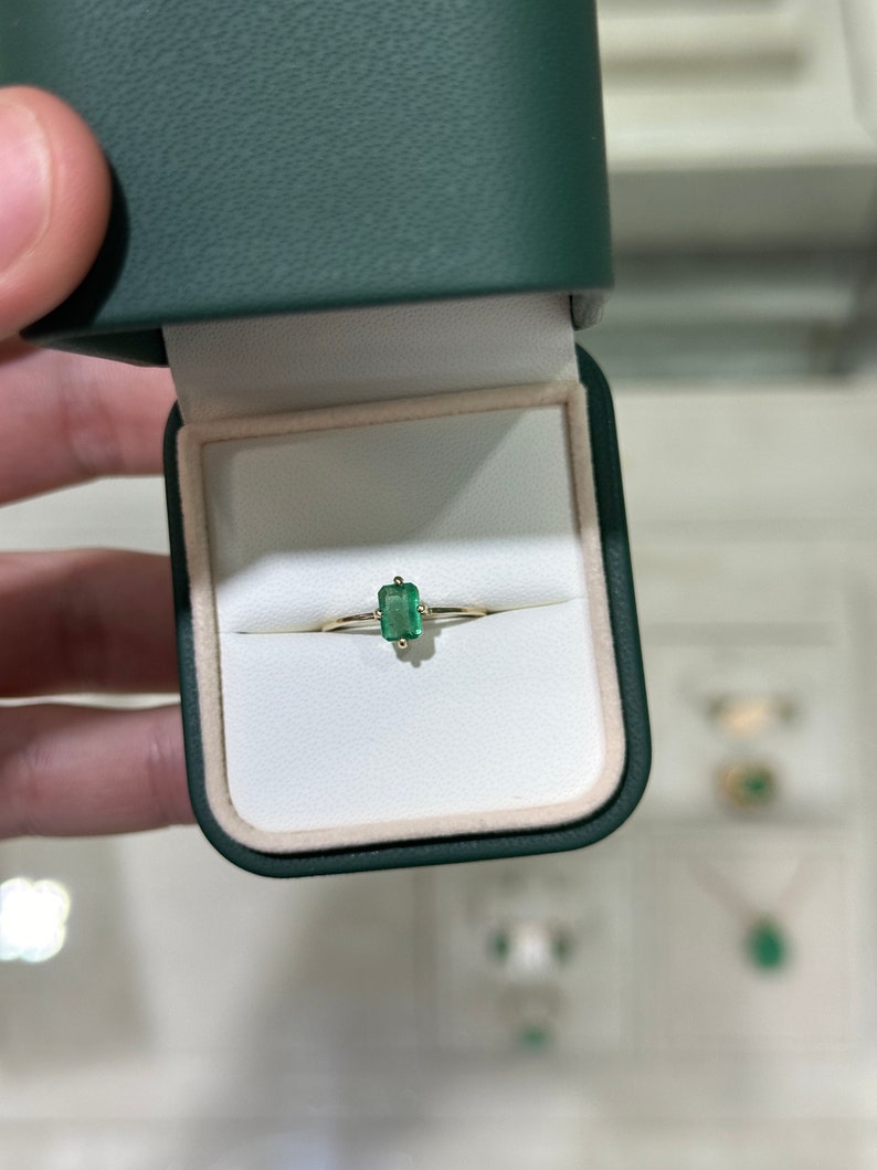 Ladies 0.70ct Colombian emerald solitaire ring with four prongs, petite accent design, set in 14K gold, right hand jewelry