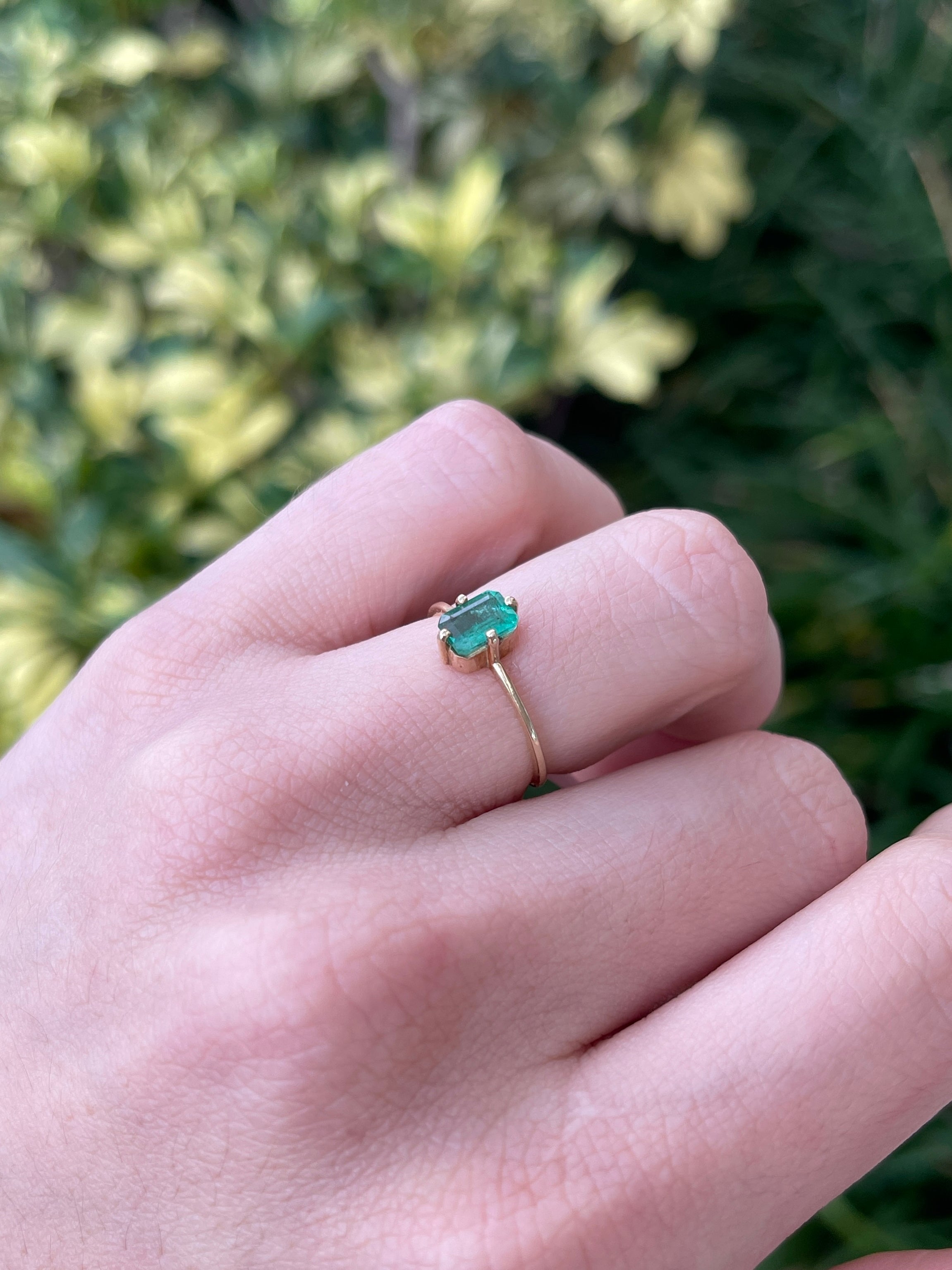 14K Colombian Emerald ladies ring with 0.70ct four-prong north-south set petite solitaire emerald on right hand.