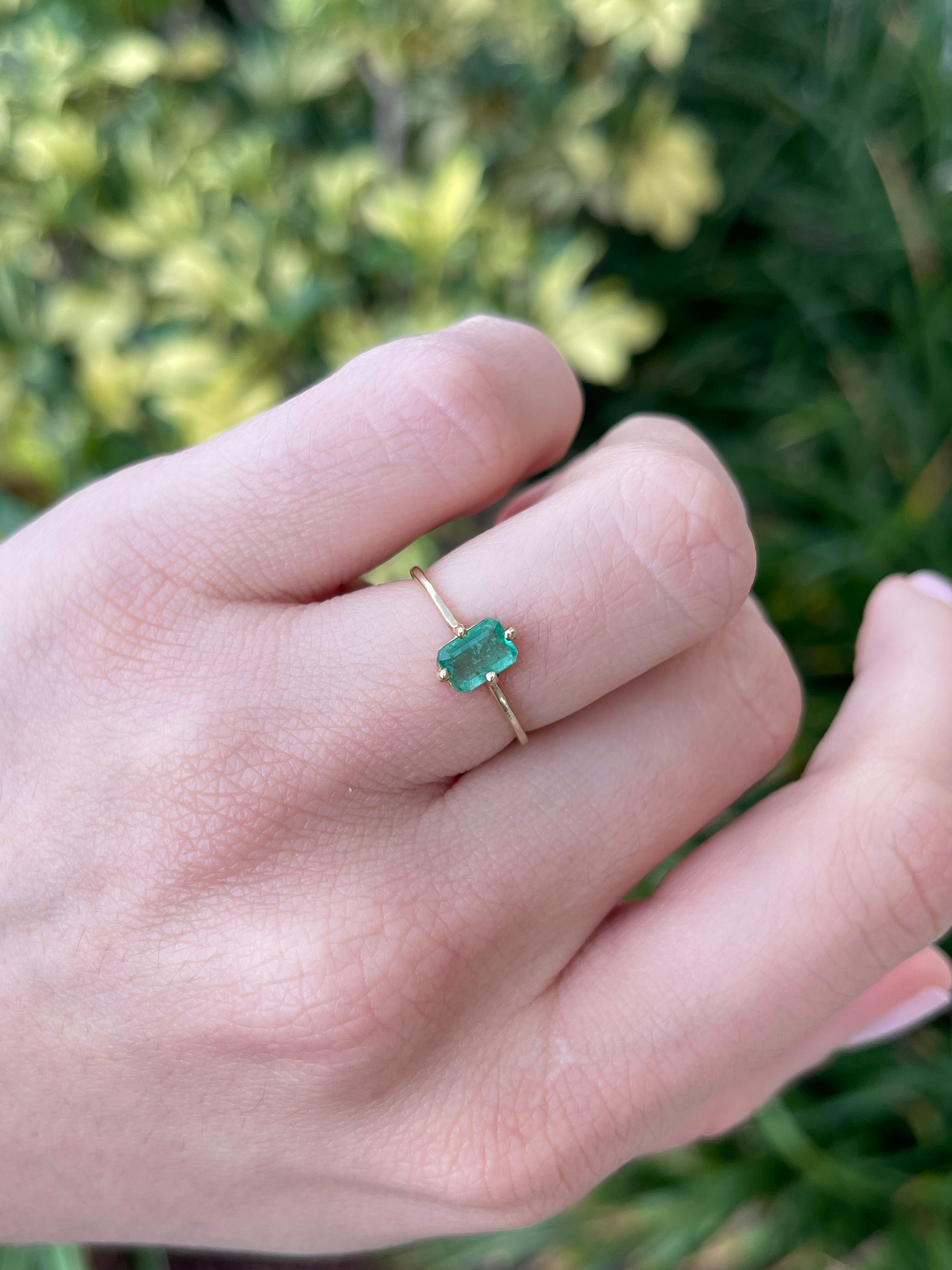 14K natural Colombian emerald solitaire ring with four prongs and petite accent design for right hand wear.