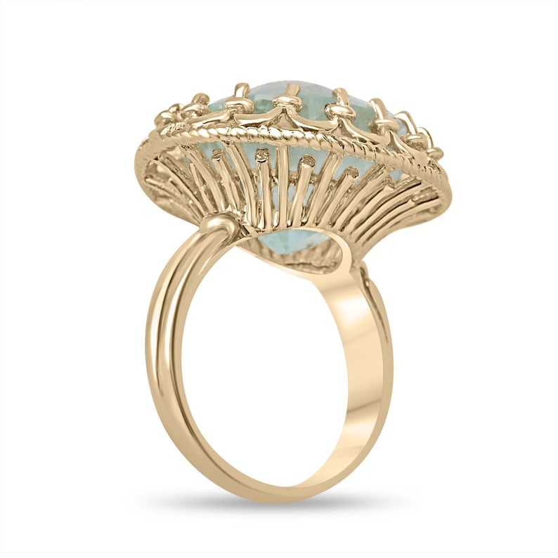 Ladies Colombian Emerald ring featuring a 16.75ct pale light green cushion cut emerald in a vintage-inspired 14K setting.