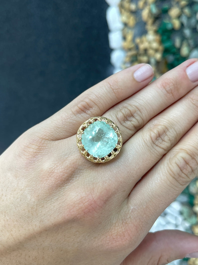 Ladies emerald ring featuring a 16.75ct pale green cushion cut Colombian emerald in a vintage-inspired 14K setting.