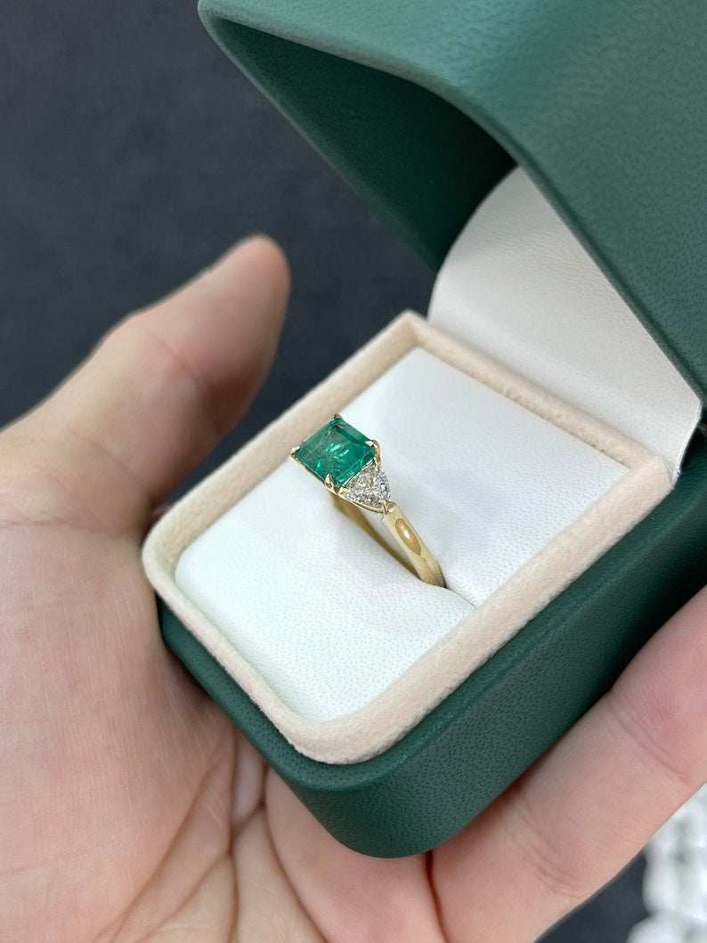 14K gold ladies emerald ring with east-west emerald and trillion cut diamonds, featuring a 2.58 tcw Colombian emerald centerpiece.