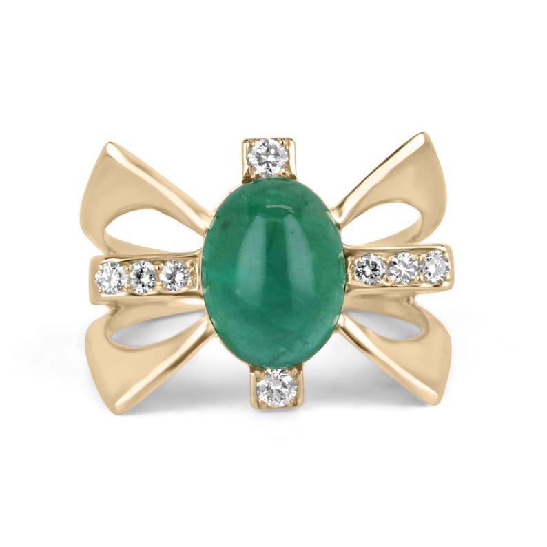 Ladies emerald ring featuring a 5.12tcw green cabochon emerald with diamond accents in a gold star styled setting.