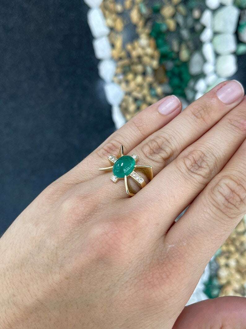 Ladies emerald ring featuring a 5.12tcw green cabochon emerald with diamond accents in gold star style, by Colombian Emerald.