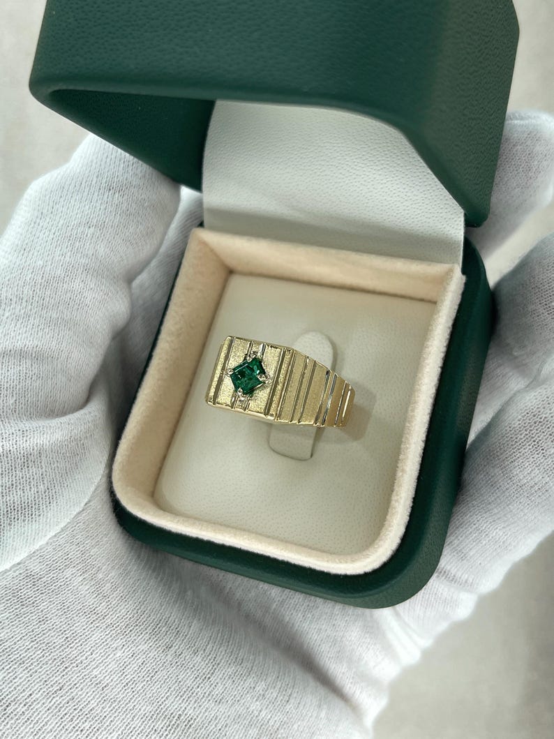 Men's 14K emerald cut pinky ring with 0.60ct rich green Colombian emerald solitaire setting.