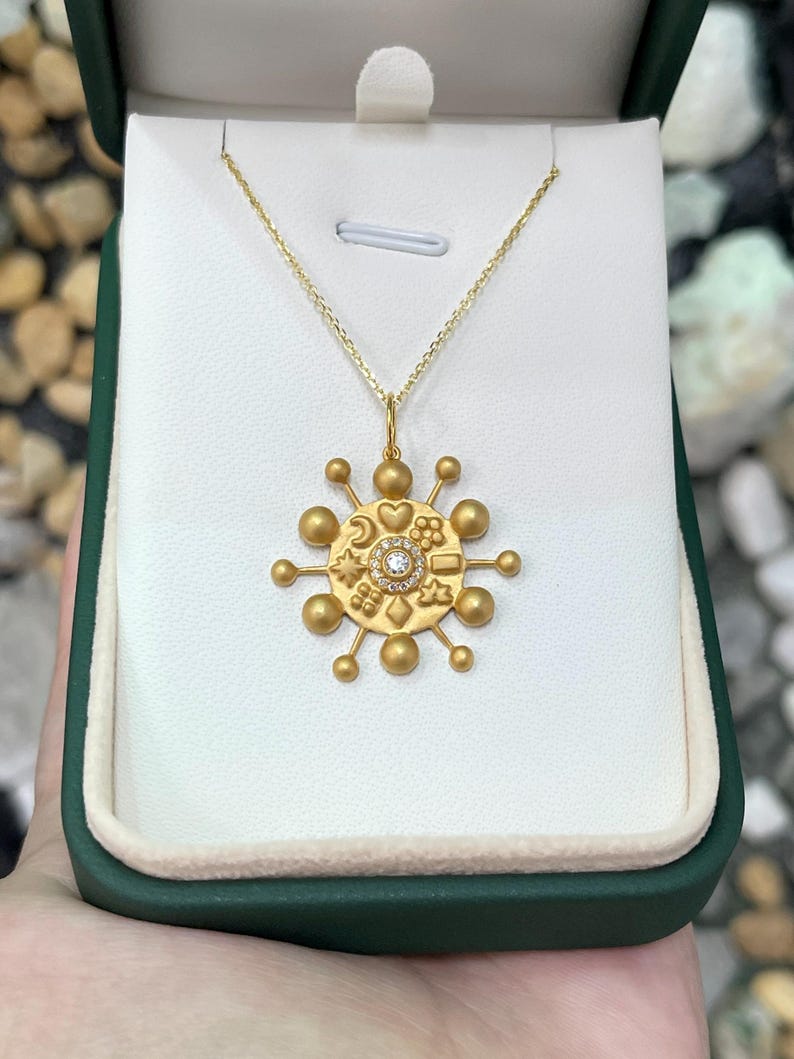 14K gold celestial pendant with 0.15tcw natural diamond from Colombian Emerald, featuring a star-shaped design.