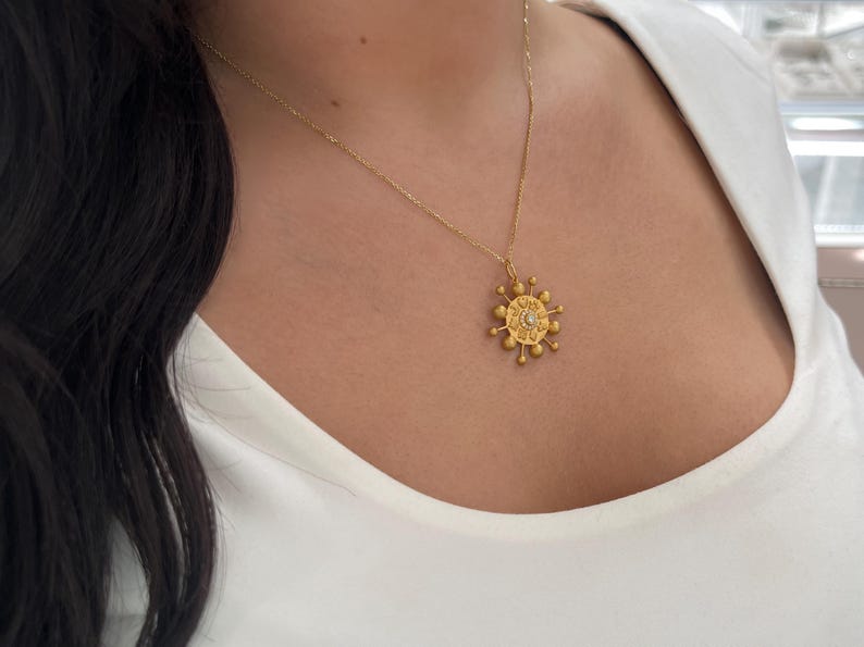 14K gold celestial pendant with 0.15tcw natural diamond, featuring a delicate design, from Colombian Emerald jewelry collection.