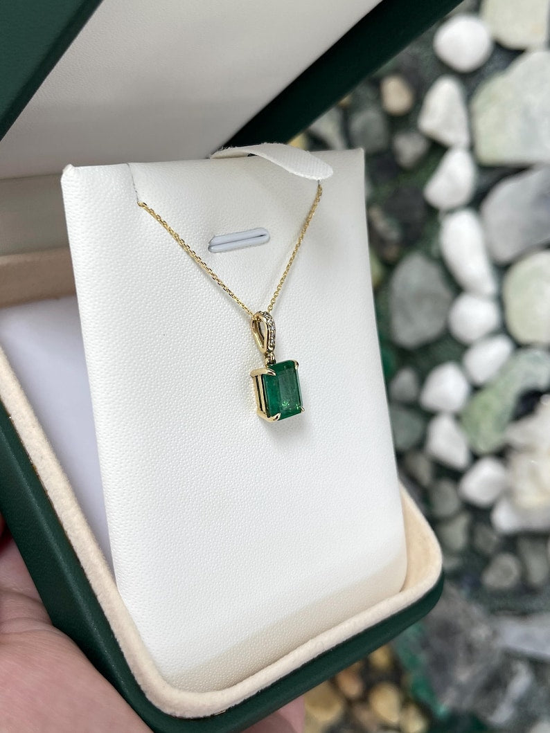 14K gold pendant necklace featuring a lush dark green emerald cut emerald with diamond accents by Colombian Emerald.