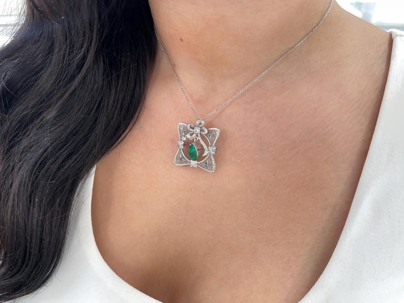 Vintage pendant with 2.65tcw Colombian emerald pear cut and diamonds, set in 14K gold, showcasing intricate craftsmanship.