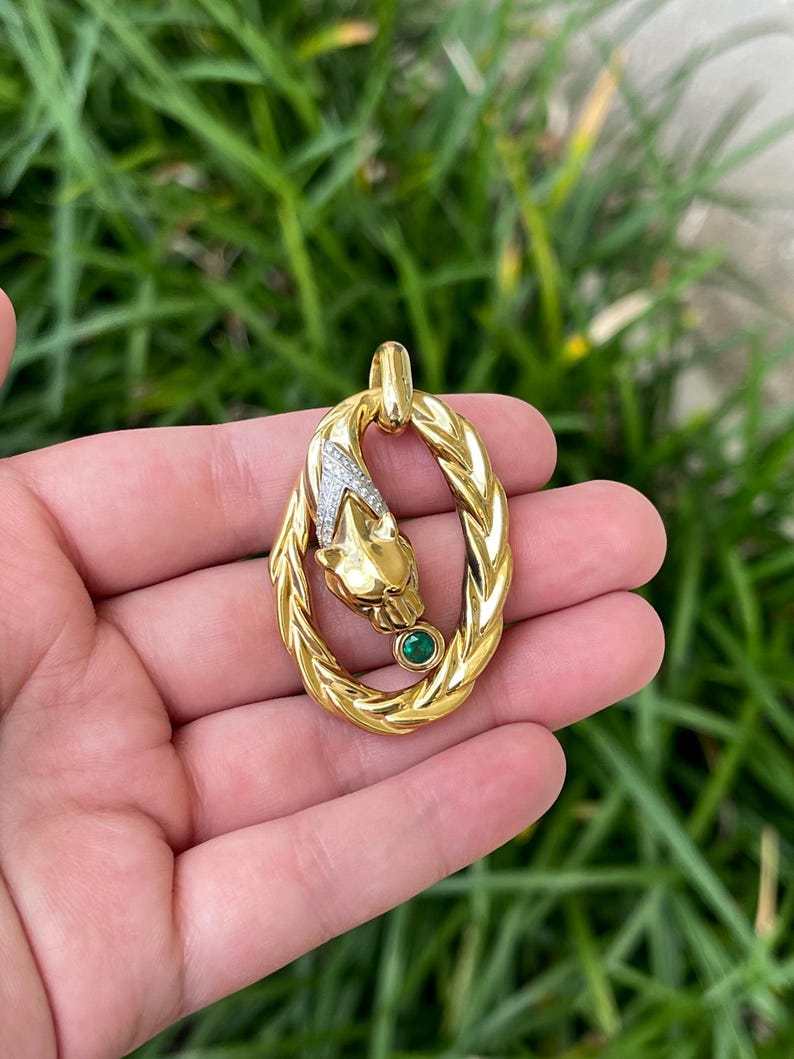 Jaguar emerald pendant in 18K yellow gold, featuring a 7.1-gram Colombian emerald pendant on a necklace.
