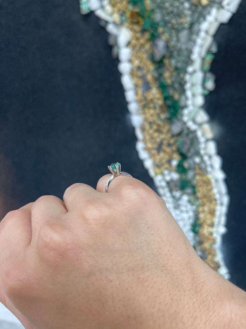 Ocean blue 0.80ct round cut Colombian Emerald engagement ring with six prongs in 14K gold.