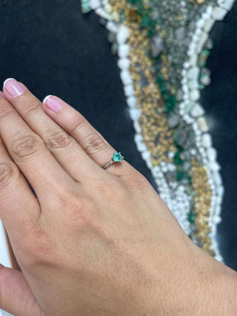 Colombian Emerald 0.80ct round cut ocean blue engagement ring with six prongs in 14K gold, showcasing a stunning gemstone setting.