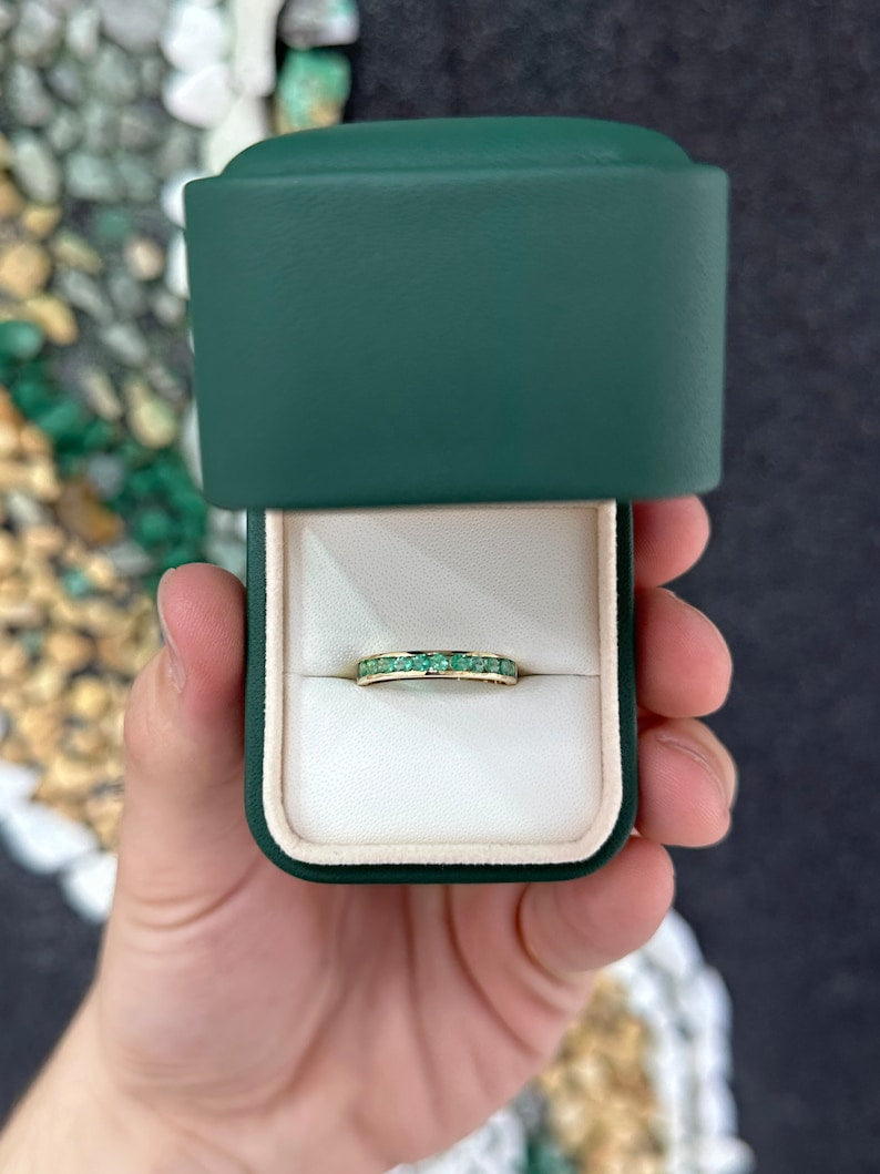 Unisex 14K gold ring with 0.80tcw round cut medium green emerald featuring a classic band design.