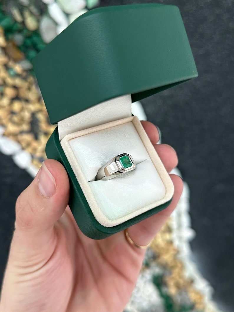Men's silver ring with a 0.90 carat vivid medium green emerald gemstone, featuring pink accents, from Colombian Emerald.